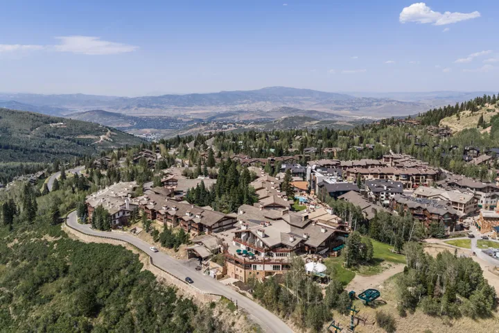 Mountain community with extensive residential structures, winding roadways, and a prominent mountain landscape