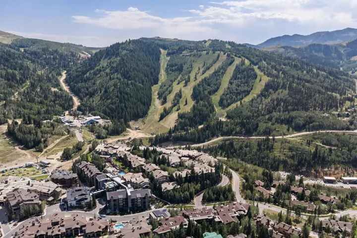 Extensive mountain landscape featuring ski runs, dense forestation, and residential development