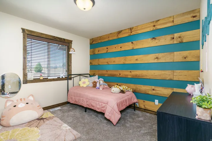 Textured accent wall with wood paneling and teal detailing