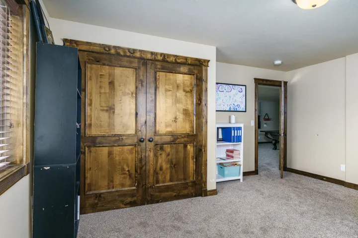 Carpeted flooring with wood trim and matching wood doors