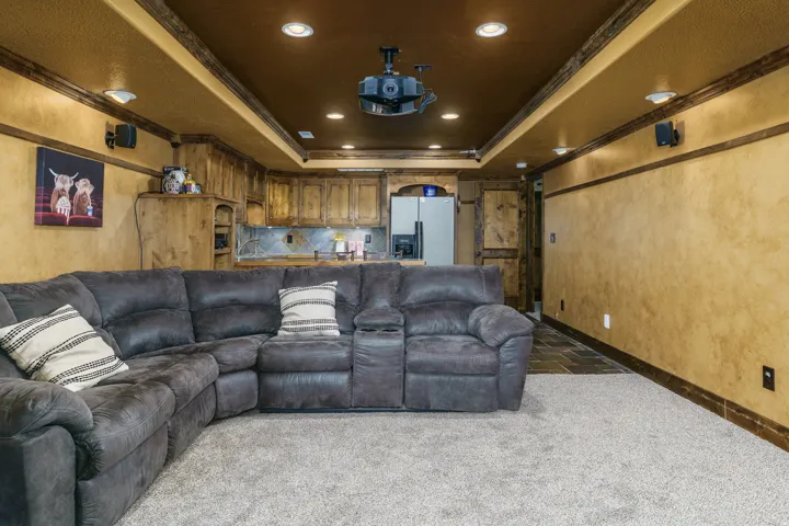 Recessed lighting, wood-finish ceiling trim, and built-in speakers define this space