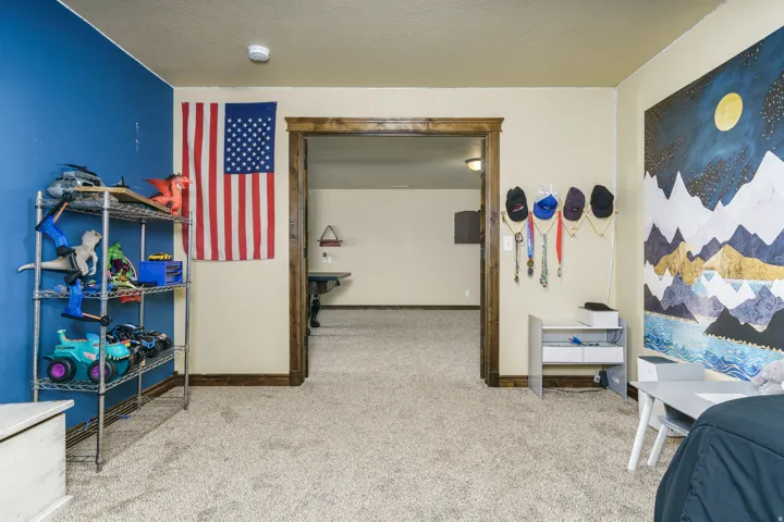 Carpeted flooring, painted walls, and wood-trimmed doorway