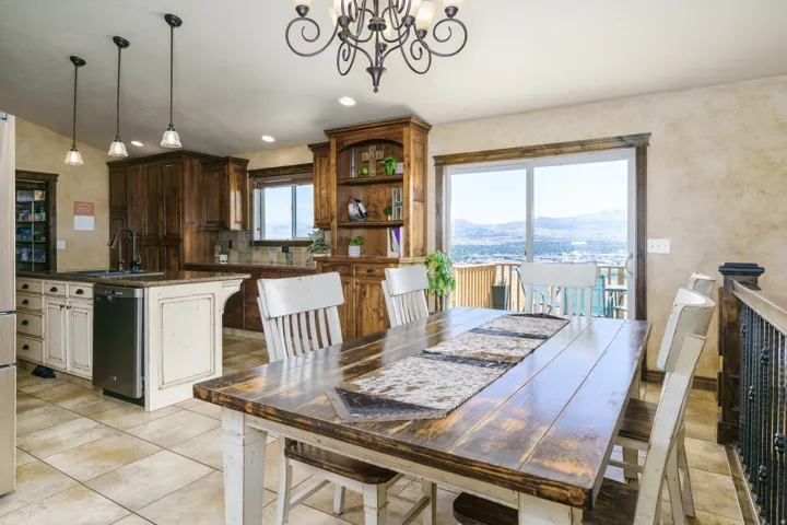Expansive kitchen and dining area featuring custom wood cabinetry, stainless steel appliances, and a large center island with seating