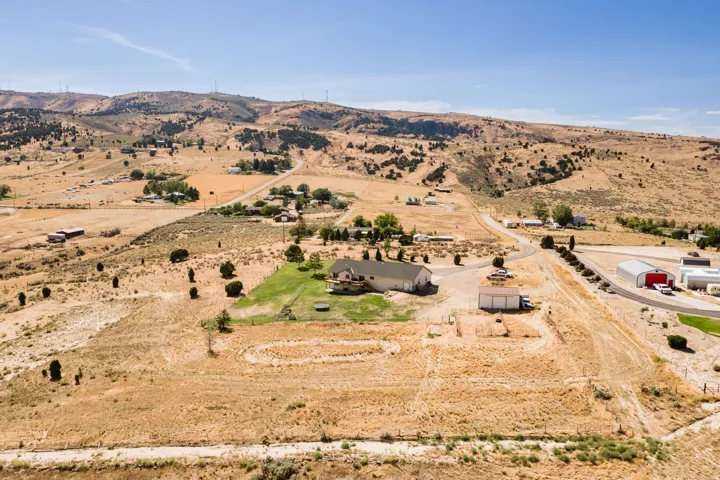 Expansive property with a single-family residence, detached garage, and surrounding arid landscape