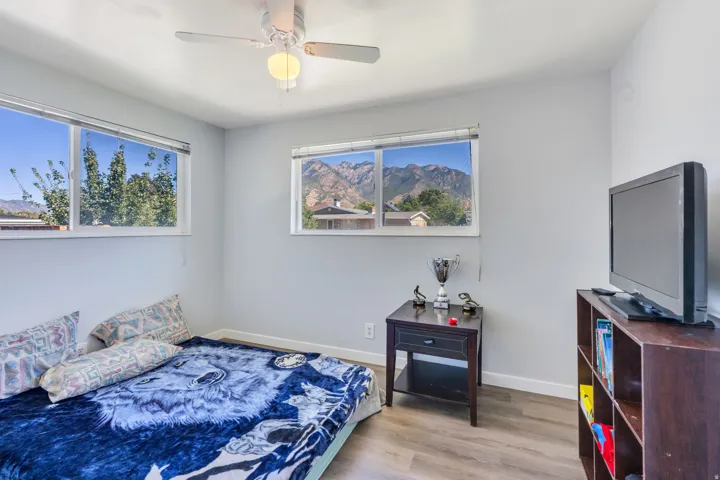 Light gray walls, wood-finish flooring, and white trim