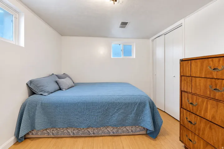 Recessed windows, overhead lighting, wood-finish flooring, and a double-door closet