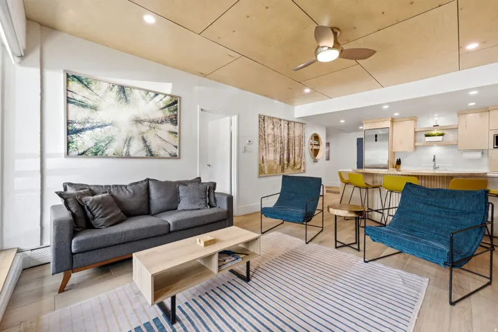 Wood-finish ceiling with recessed lighting and a ceiling fan
