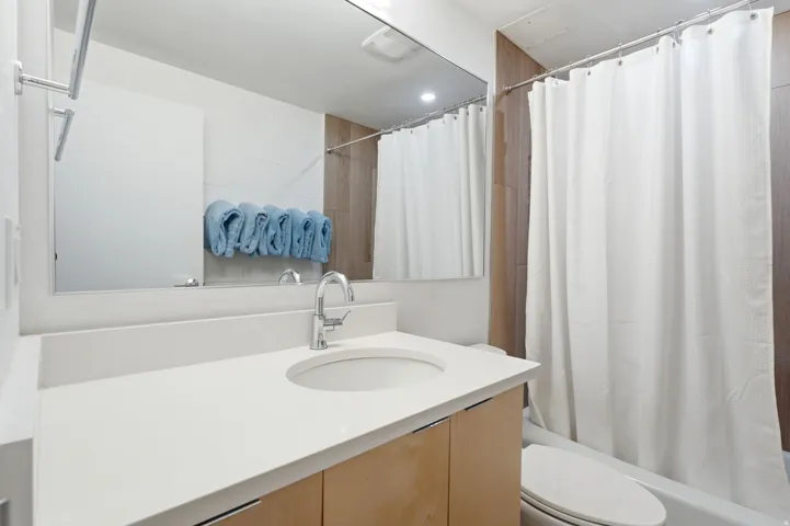 Floating Vanity with Quartz Counter tops. Tub shower
