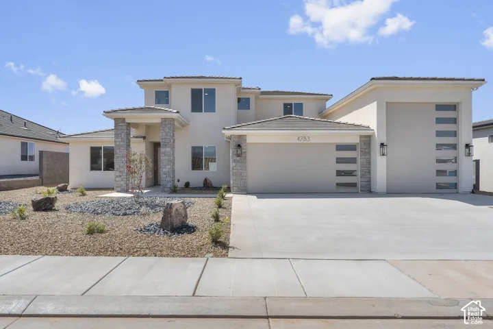 Stucco exterior with stone accents and a covered entry