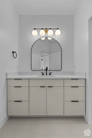 Floating vanity with integrated basin, matte black faucet, and white countertop