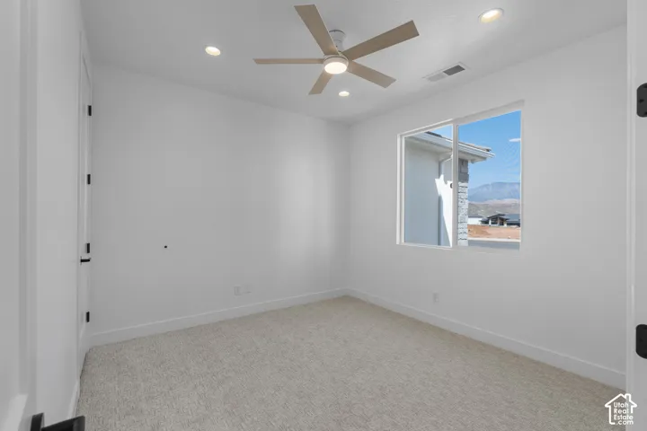 Room featuring light-colored carpet flooring, recessed lighting, and a ceiling fan with light-toned blades
