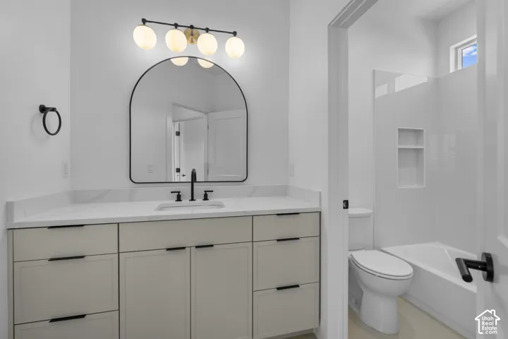 White vanity with a quartz-finish countertop and matte black fixtures