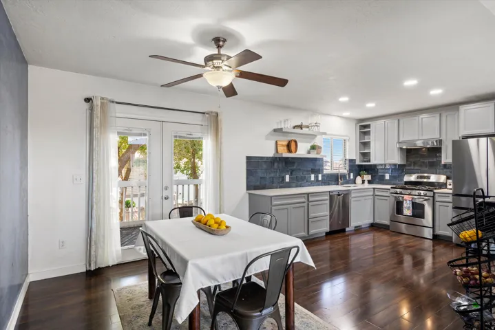 Kitchen with wood-finish flooring, recessed lighting, and stainless steel appliances