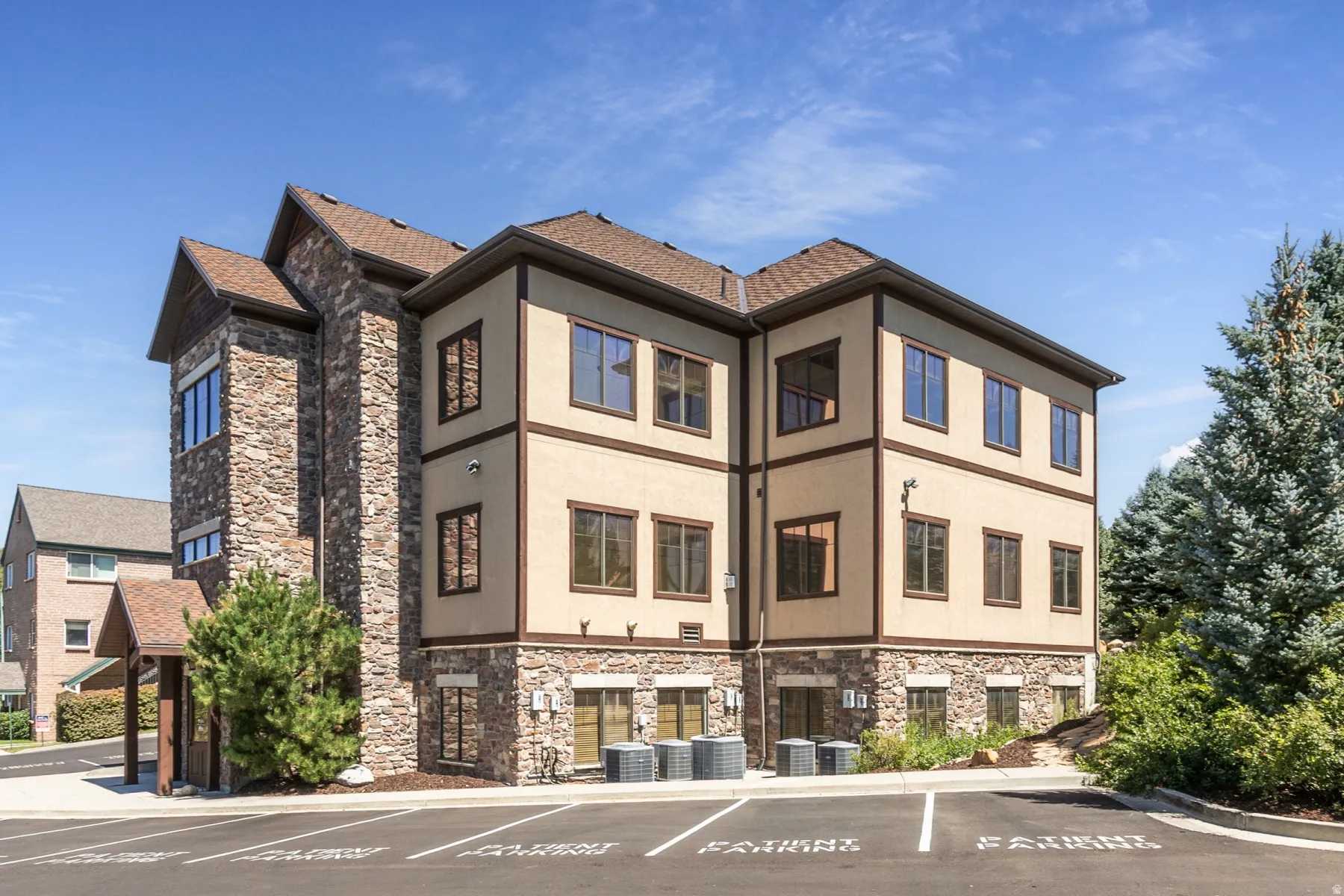 Multi-level building with stone and stucco facade