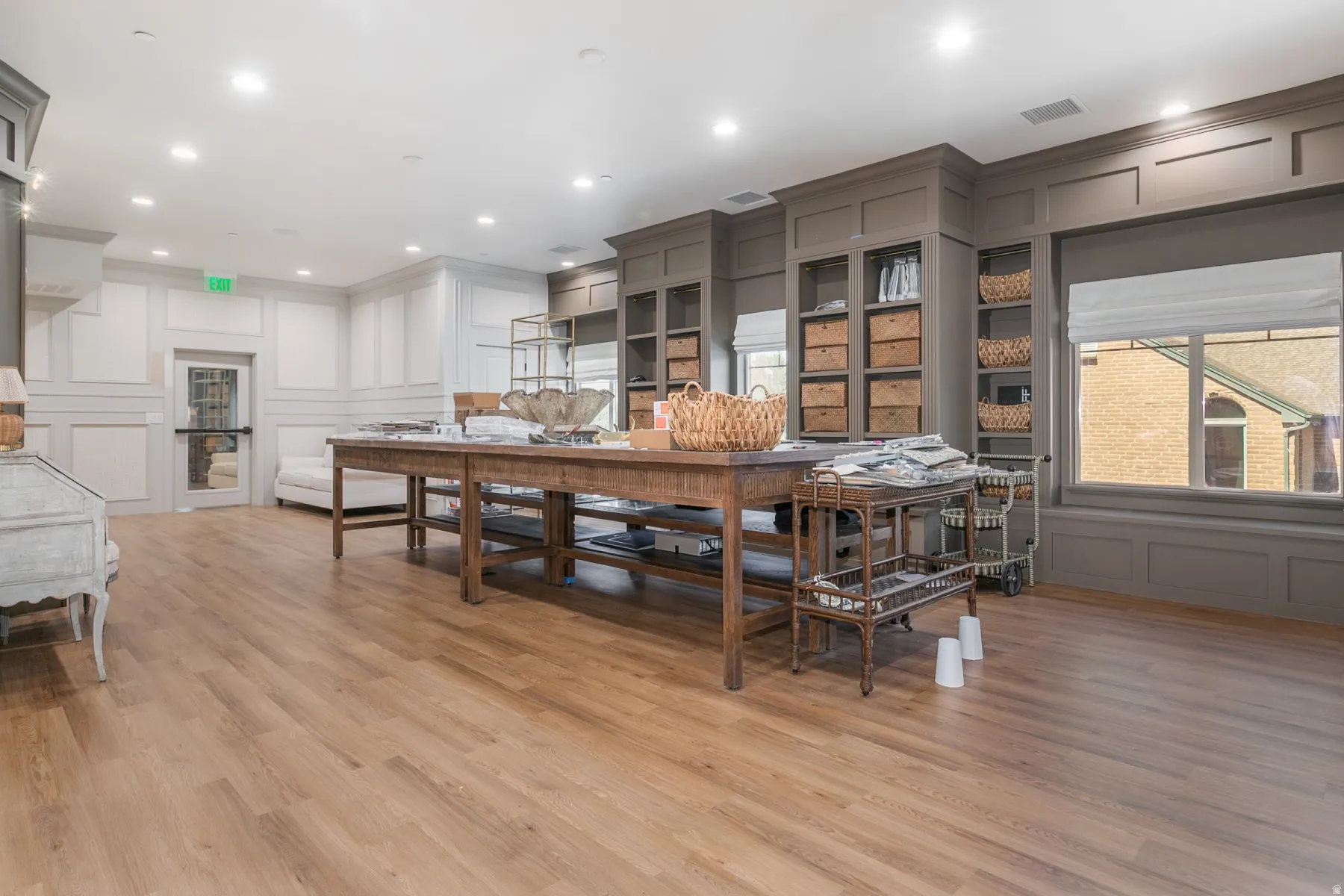 Recessed lighting, wood-finish flooring, built-in shelving, paneling, and large windows