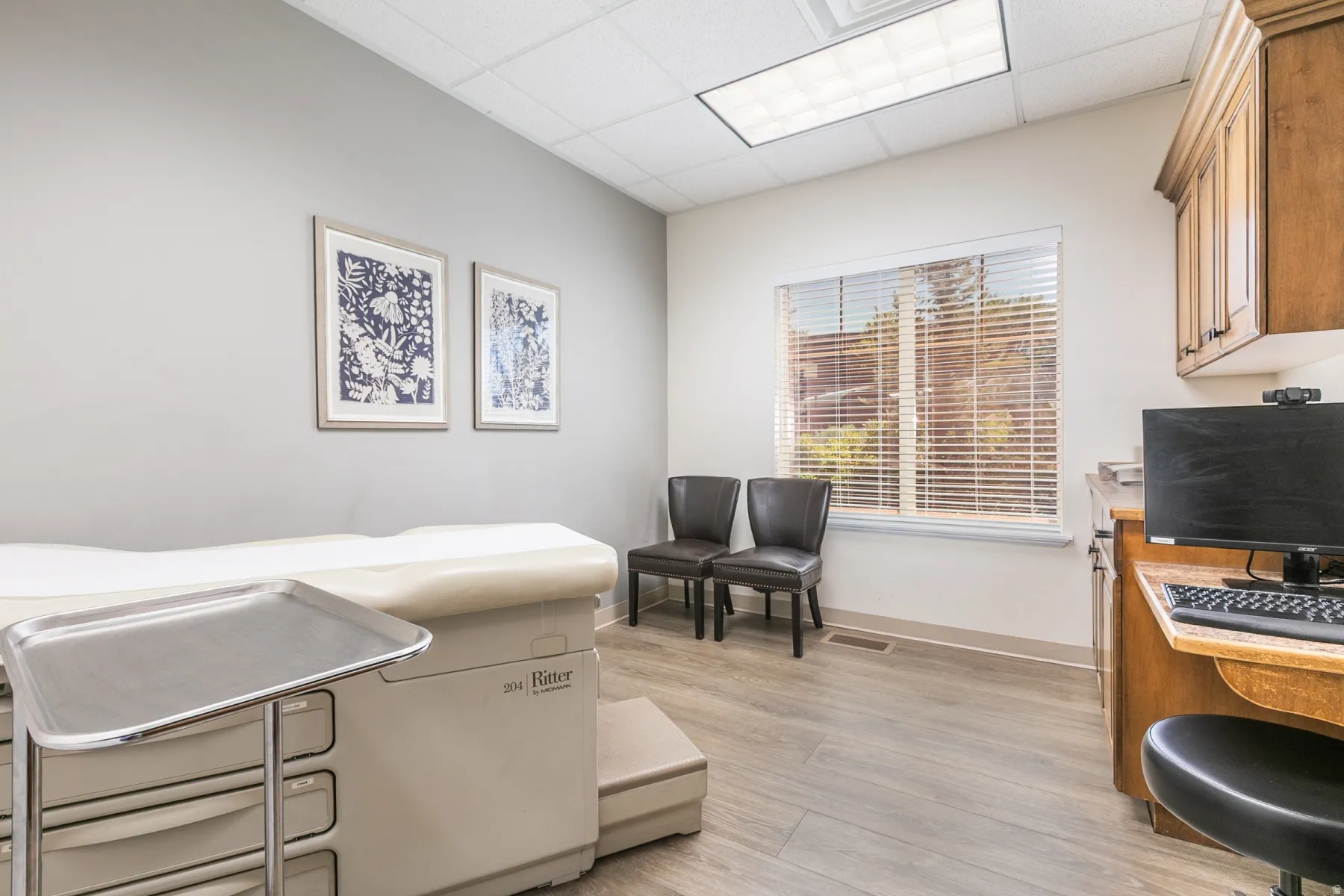 Wood-finish flooring, recessed lighting, and a window with blinds