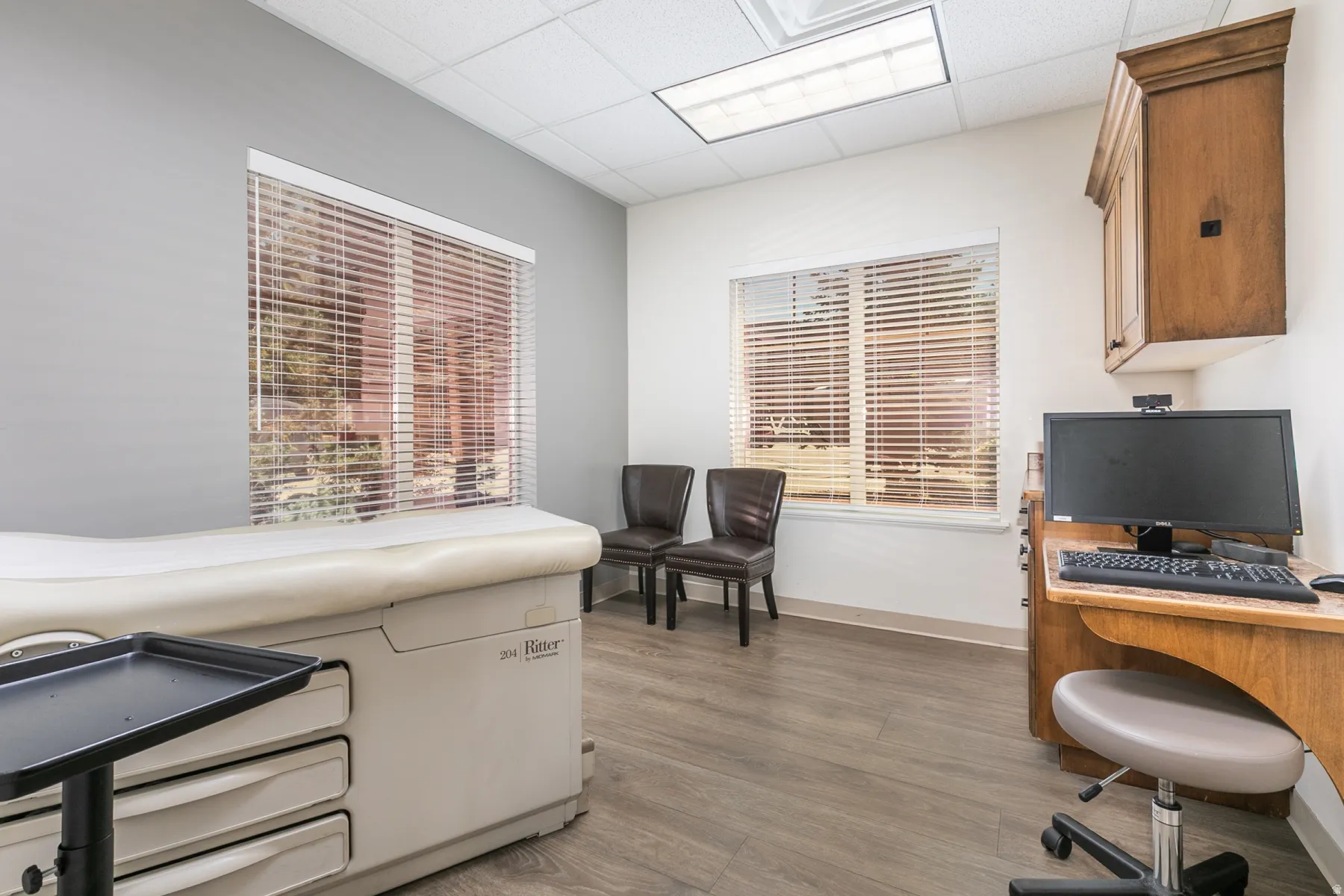 Wood-finish flooring with neutral wall tones and multiple windows
