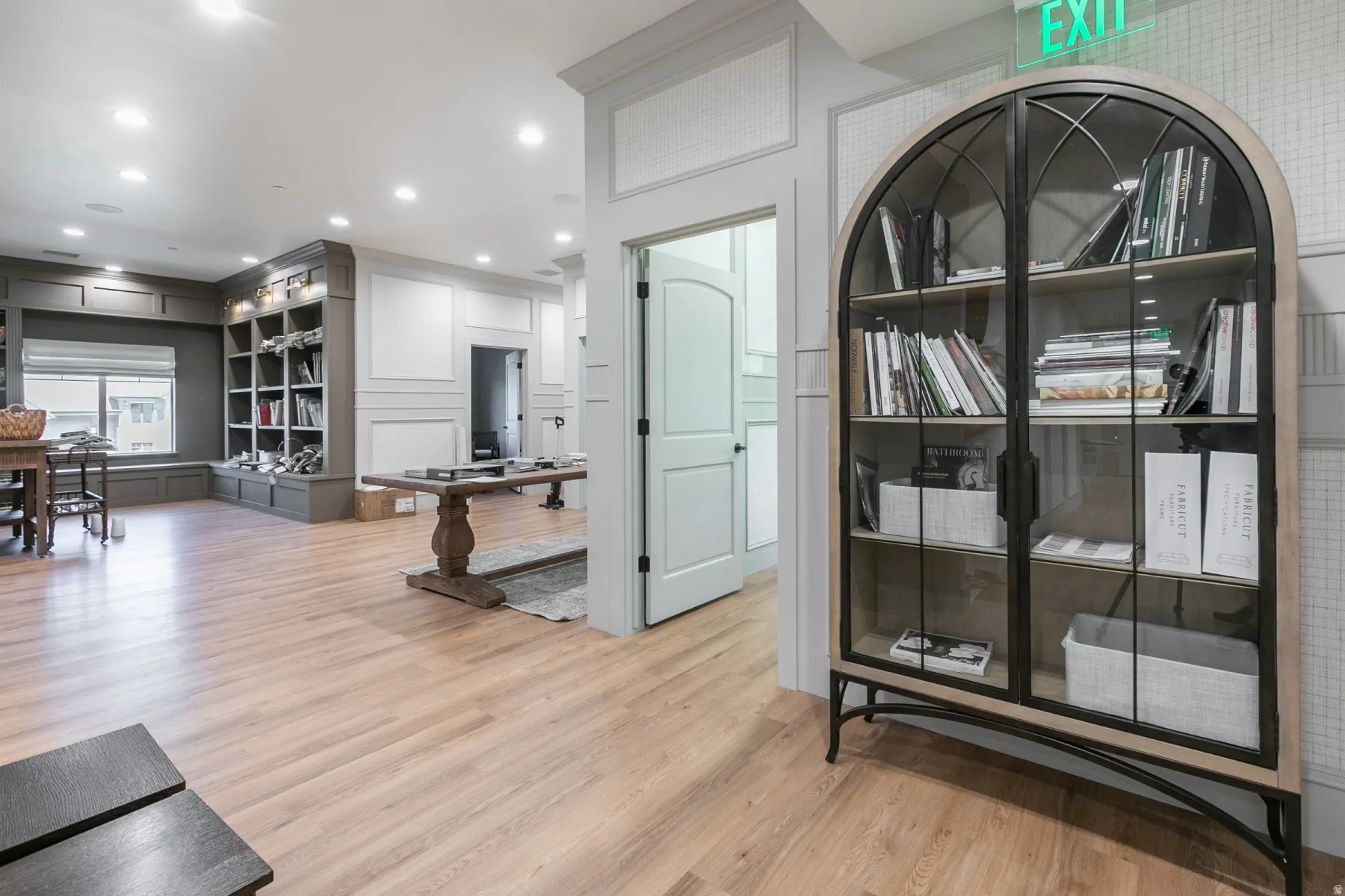 Wood-finish flooring, recessed lighting, and wall paneling