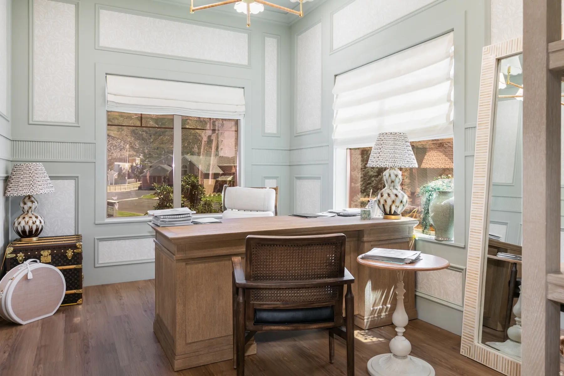 Wood-finish flooring with a large window featuring a custom shade