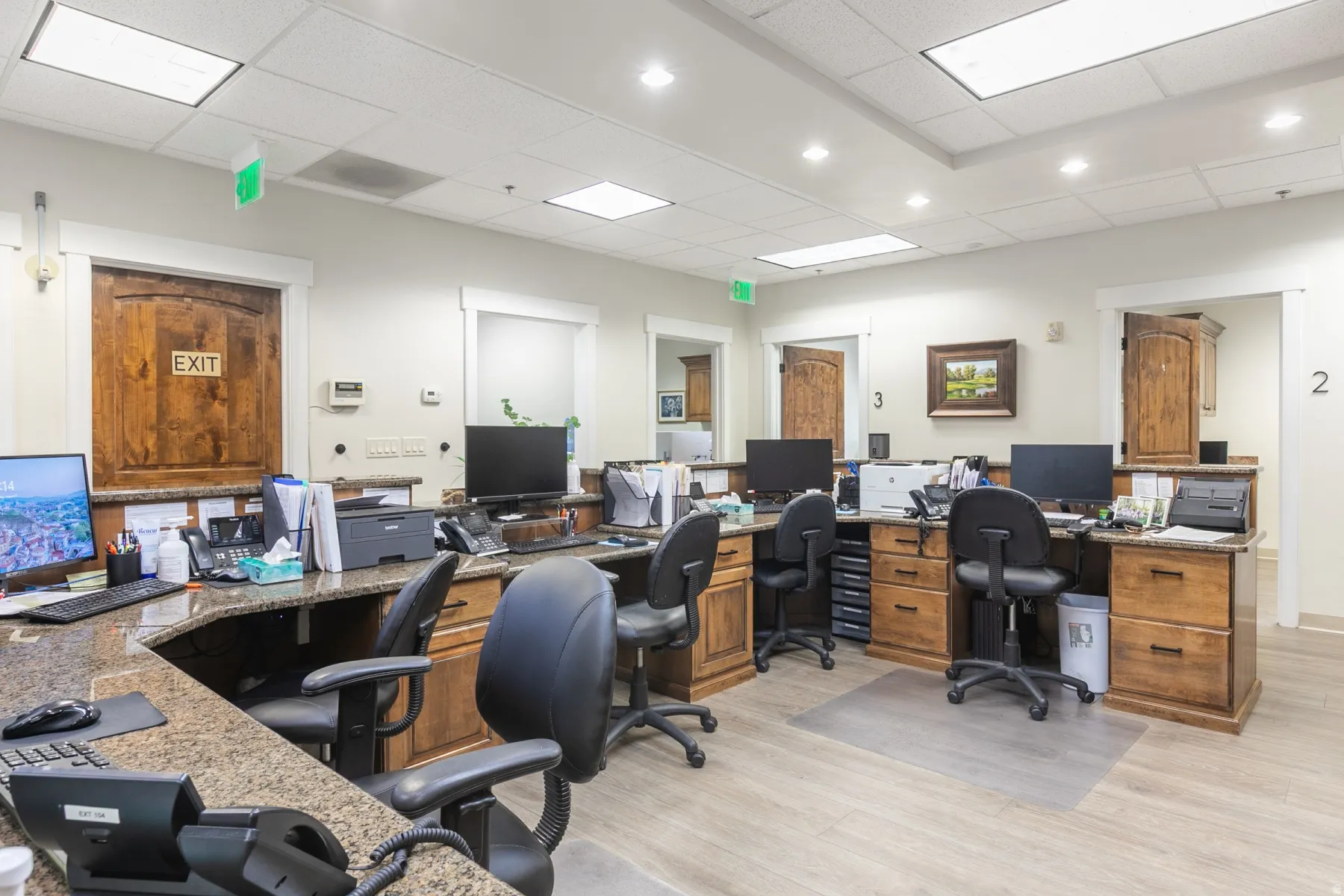 Workstation area featuring wood-finish flooring, recessed lighting, and built-in wood cabinetry