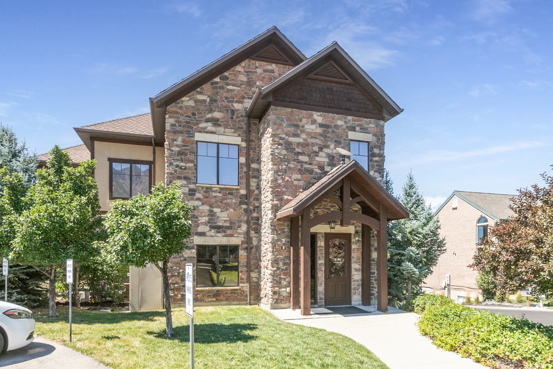 Stone and stucco exterior with multiple gables