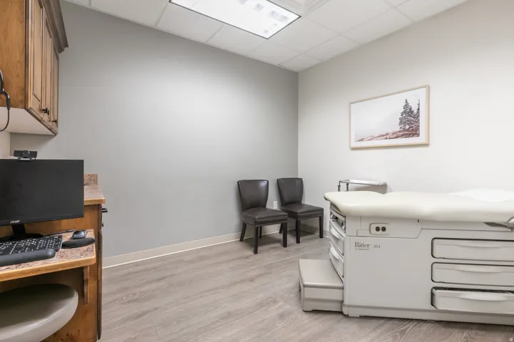 Wood-finish flooring with light gray walls and a drop ceiling