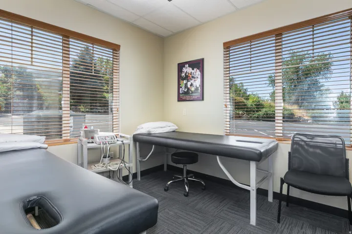 Two large windows with wood-finish blinds