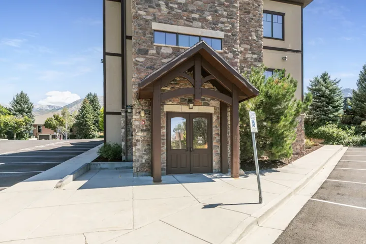 Stone veneer exterior with a covered entry
