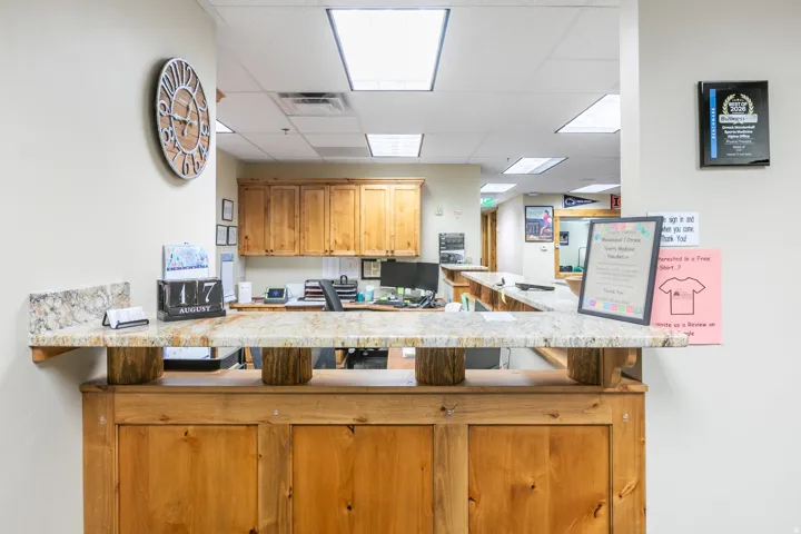 Wood-finish reception desk with a stone-finish countertop