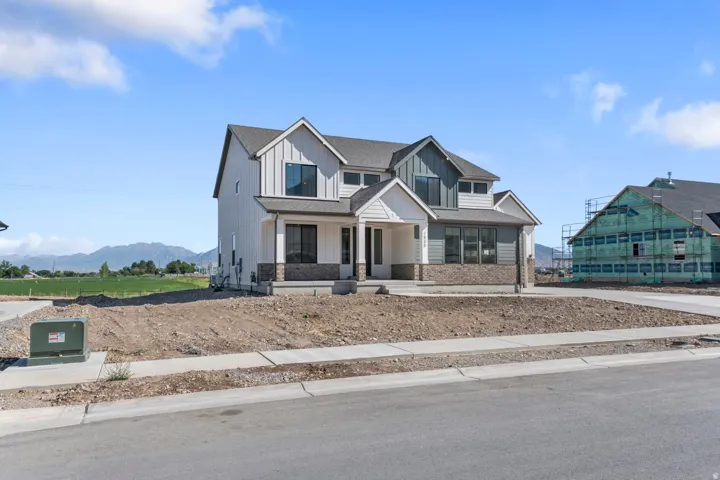 Contemporary exterior with a covered entry, board and batten siding, horizontal siding, and stone accents