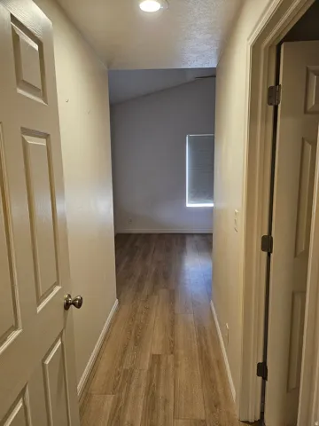Wood-finish flooring extending through the hallway