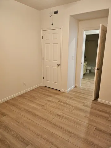 Wood-finish flooring with white baseboards