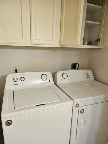 White shaker-style cabinetry with upper shelving