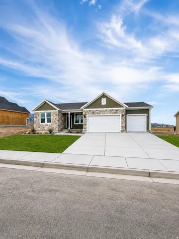 Stone and siding exterior with a two-car garage and a one-car garage