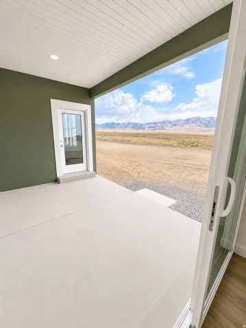 Covered patio with recessed lighting, concrete flooring, and a glass-paneled door
