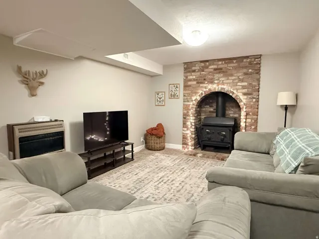 Exposed brick fireplace with a wood-burning stove
