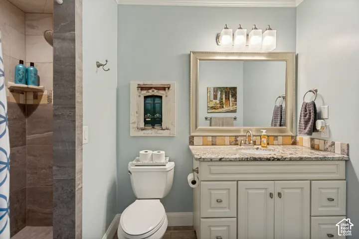 Granite countertop vanity with shaker-style cabinetry, a drop-in sink, and a framed mirror