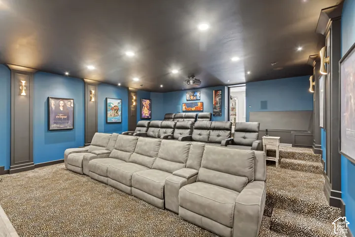 Tiered seating with patterned carpet and wall sconces