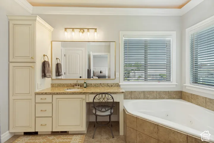 Built-in vanity with a single sink, light-toned countertop, and gold-toned fixtures