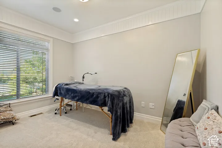 Wall-to-wall carpeting with recessed lighting and crown molding