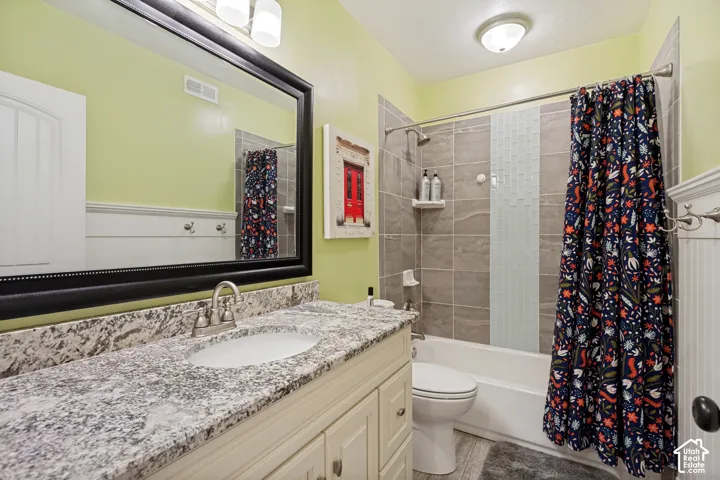 Vanity with a granite countertop, undermount sink, and brushed nickel faucet
