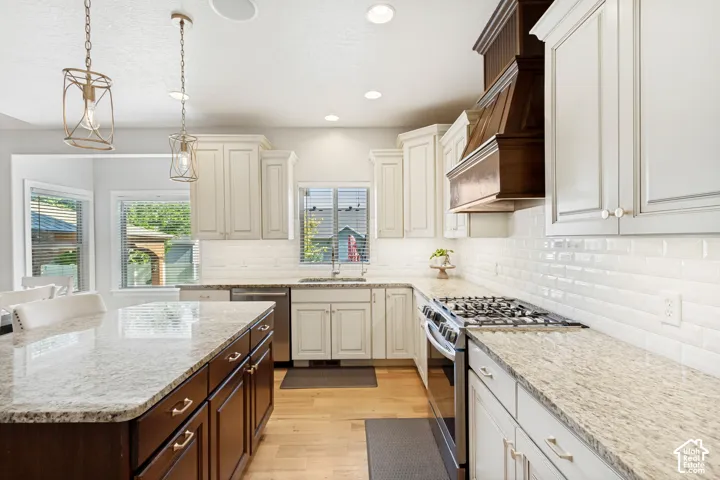 Kitchen featuring an expansive island with a granite countertop, white shaker cabinetry, stainless steel appliances, a tile backsplash, and wood-finish flooring
