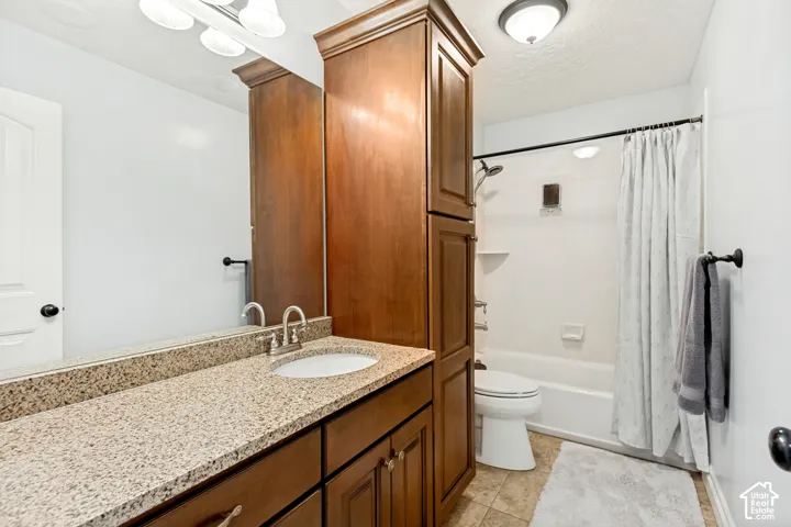 Vanity with a granite-look countertop, integrated sink, and brushed nickel faucet