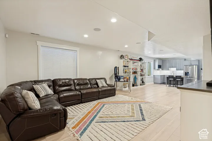 Recessed lighting illuminating light wood-finish flooring