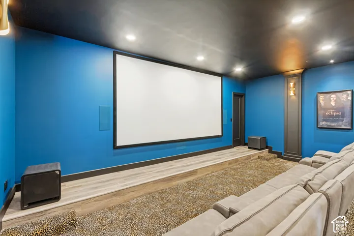 Dedicated media room featuring a large projection screen and tiered seating