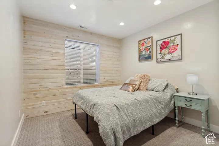 Shiplap accent wall, recessed ceiling lighting, carpeted flooring, window with blinds