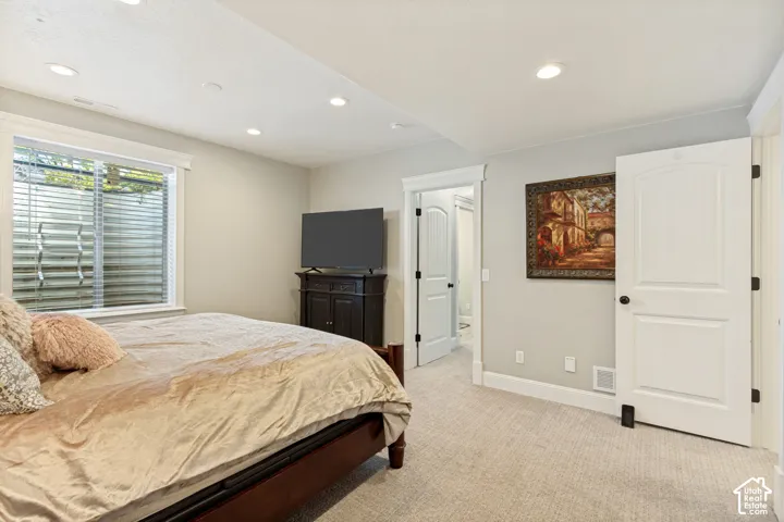 Recessed lighting and a window with white blinds