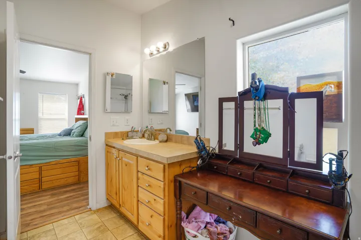 Light wood-finish vanity with an integrated sink and mirror
