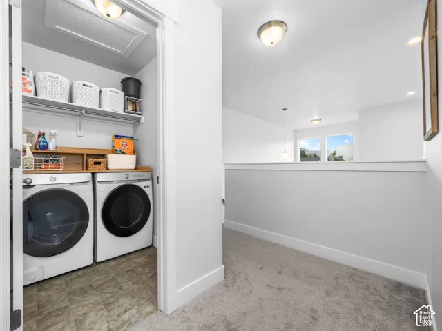 Laundry area with built-in shelving, wood-finish countertop, and tiled flooring