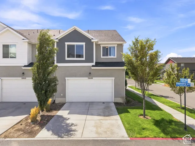 Two-story stucco and siding exterior with an attached garage